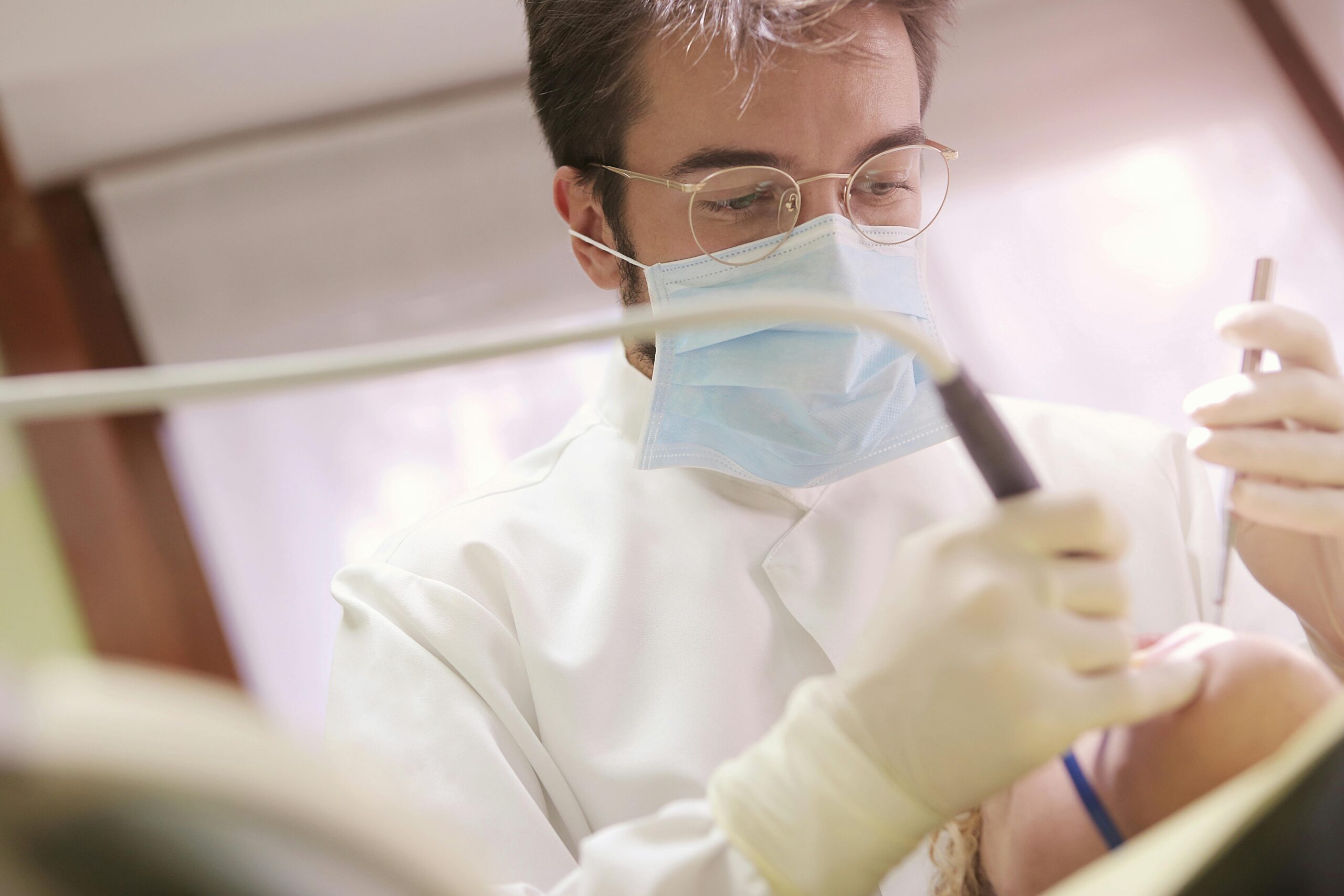 Close-up of a dentist performing a dental procedure on a patient using modern tools.